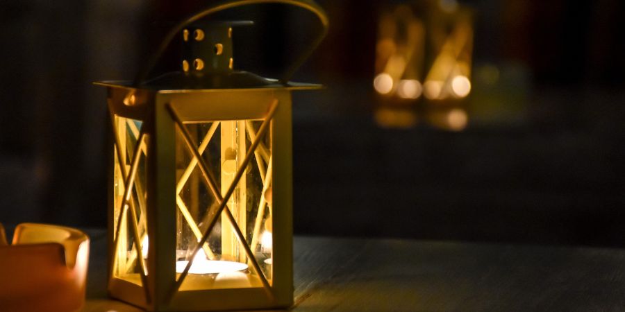 Halloween interior design with a glowing lantern candle centerpiece creating warm and spooky seasonal ambiance.