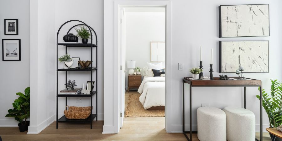 Bright modern apartment entryway and bedroom featured in an interior design portfolio example, highlighting minimalist decor and cohesive styling.