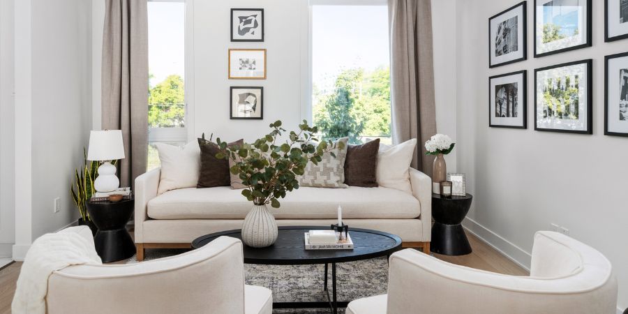 Bright modern living room with neutral furnishings and curated wall art, featured in an interior designer portfolio to highlight balance, texture, and professional styling.