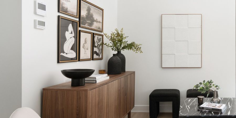 Stylish modern living room vignette with framed art and wood sideboard, illustrating how to create an interior design portfolio with no experience through simple, elegant styling.