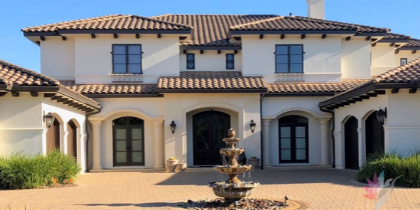 After: the same Mediterranean-style home in a lighter cream-white palette with dark doors and window frames