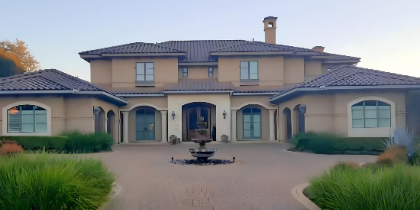 Before: Mediterranean-style home exterior with warm tan stucco