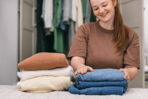 how to become a professional organizer - woman folding clothes