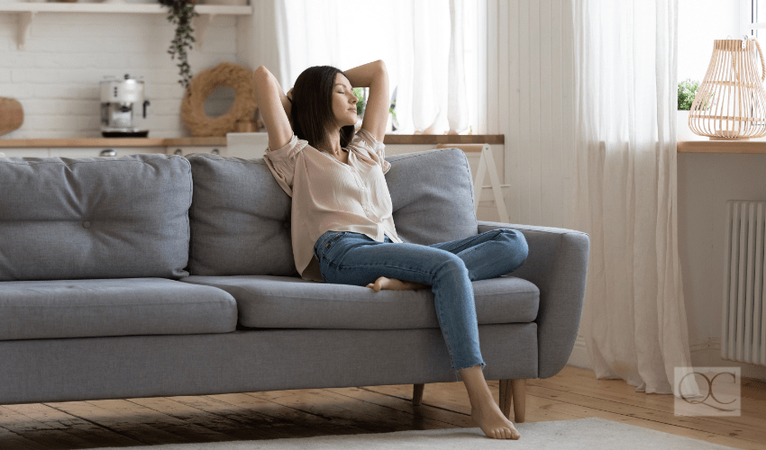 feng shui woman peaceful on living room couch