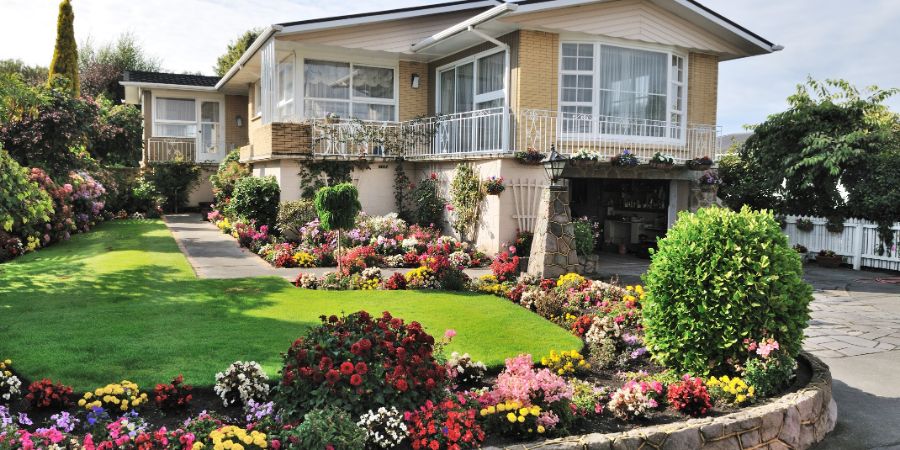 beautiful home with beautiful flowers garden - property front estate mortgage private construction. Landscape design business article.