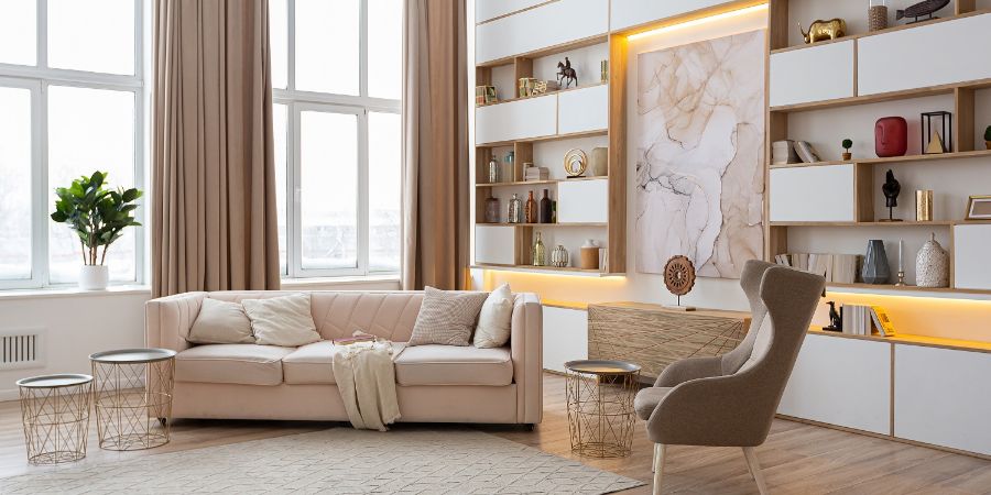 interior design spacious bright studio apartment in Scandinavian style and warm pastel white and beige colors. trendy furniture in the living area and modern details in the kitchen area. Budgeting tips article.
