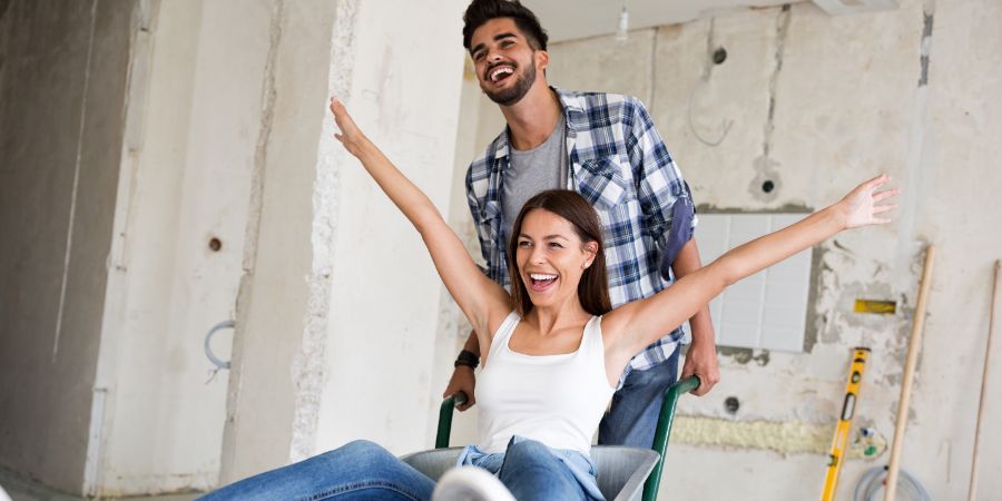 Loving couple is having fun while they are renovating home. Home renovation living article.