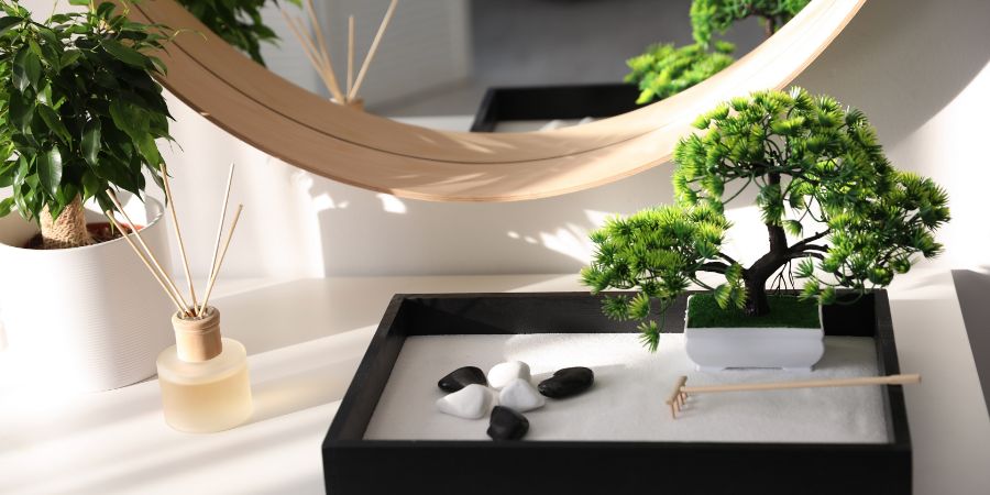 Beautiful miniature zen garden on white table indoors. Design article.